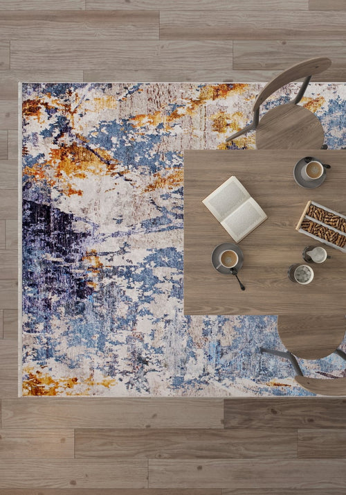 Load image 1 in gallery view. Overhead view of a wooden table for two with snacks, coffee, and an open book on the Enigmatic Elegance - Washable Rug - JR787, featuring abstract blue patterns—perfect for high-traffic areas atop a wooden floor.