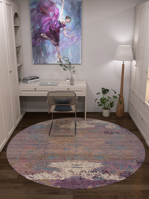Load image 1 in gallery view. A cozy home office with a white desk, rattan chair, Faerie Weave - Washable Rug - JRS005 (Custom Size) featuring colorful patterns, floor lamp, potted plants, and a painting of a dancer in purple—ideal for high-traffic spaces.