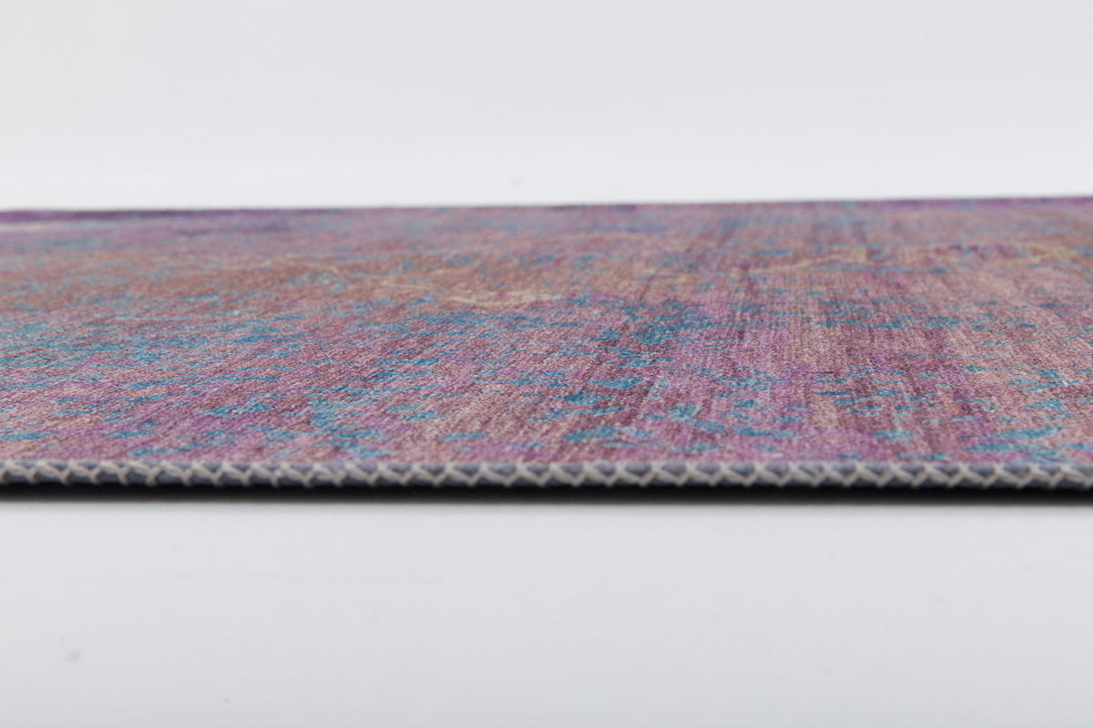 A close-up side view of the Faerie Weave - Washable Rug - JRS005 (Custom Size) highlights its multicolored design in purple, blue, and pink on a white background, with visible texture and thin edge—ideal for high-traffic areas.