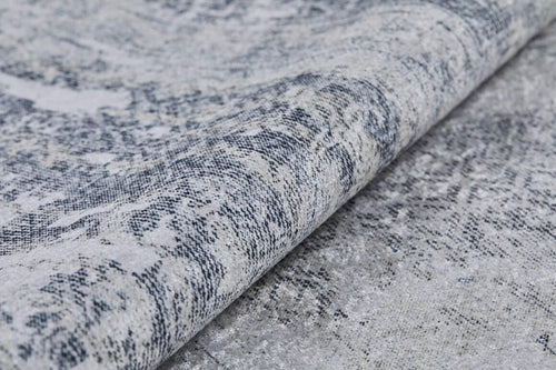 Bild 1 in Galerieansicht laden. Close-up of the Faint Memories - Washable Rug - JR1437 (Custom Size) in gray and white, featuring a textured, patterned surface with a folded edge and an intricate distressed design.