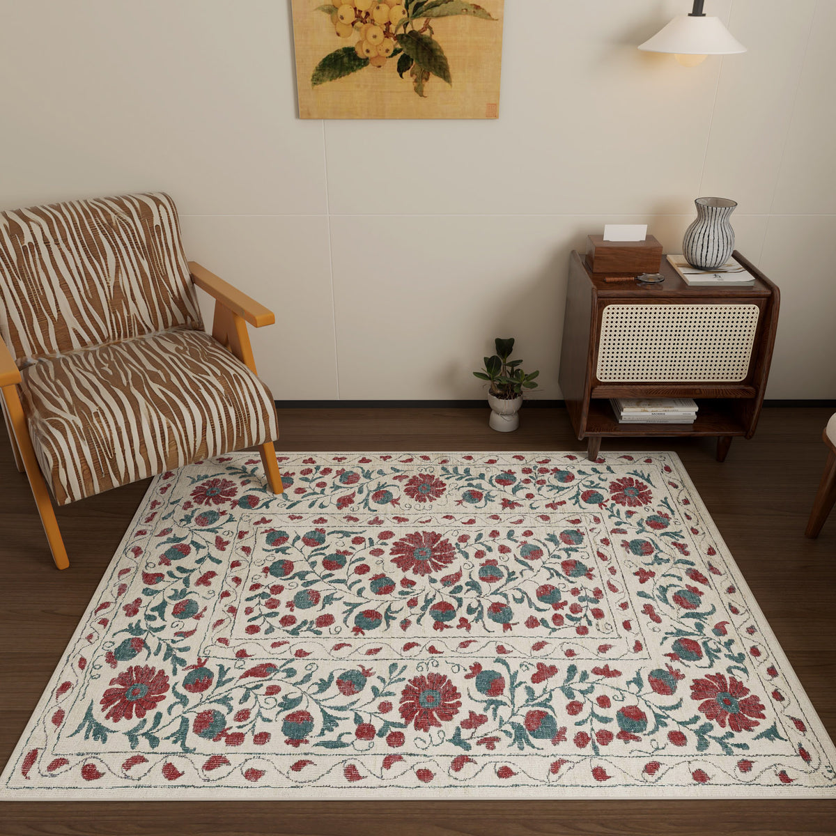 A cozy room with a zebra-print armchair, the Floral Ivory - Washable Rug - JRN1025 (Custom Size) featuring red, green, and blue florals—ideal for high-traffic areas—a small plant, a wooden cabinet with books and vase, and a wall lamp under botanical art.