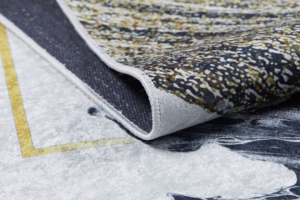 Close-up of the Funky Floral Frenzy - Machine-Washable Rug JR1376 (Custom Size), showing its textured corner in gray, black, white, and yellow—perfect for high-traffic areas.