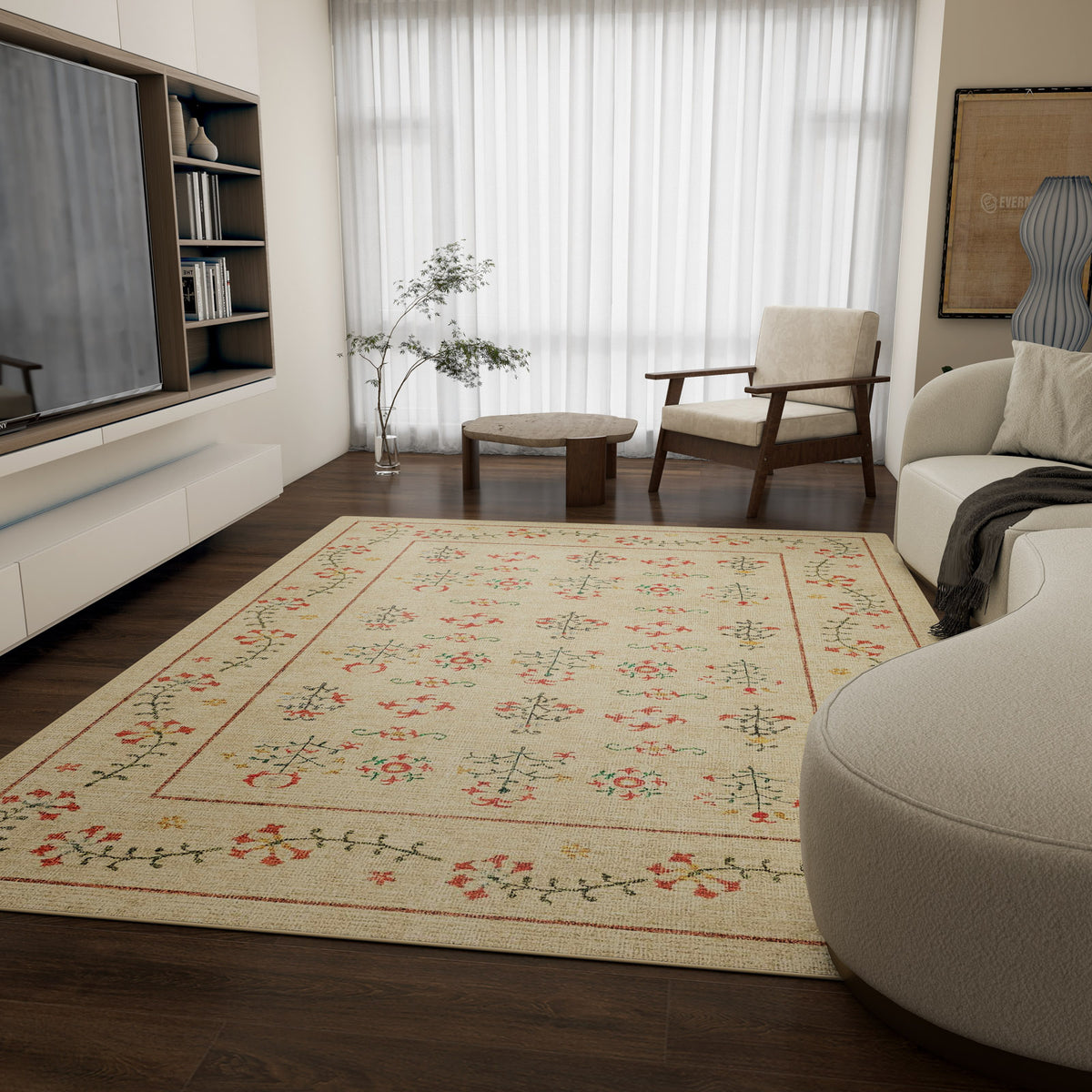 A modern living room with dark wood floors, the Garden Cream - Washable Rug - JRN1026 (Custom Size) featuring light floral motifs—ideal for high-traffic areas—minimalist furniture, a TV, open shelves, and a large window with sheer curtains.