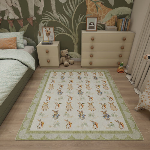 Bild 1 in Galerieansicht laden. Cream rug with a repeating Peter Rabbit pattern and green scalloped border, styled in a children's bedroom.
