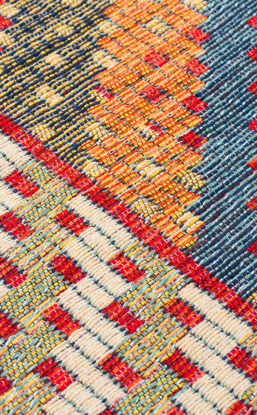 Load image 1 in gallery view. Close-up of the Garnet Print - Washable Reversible Kilim (NMD10), a flatwoven rug with geometric patterns in red, yellow, orange, blue, and white, highlighting its textured surface and visible threads.