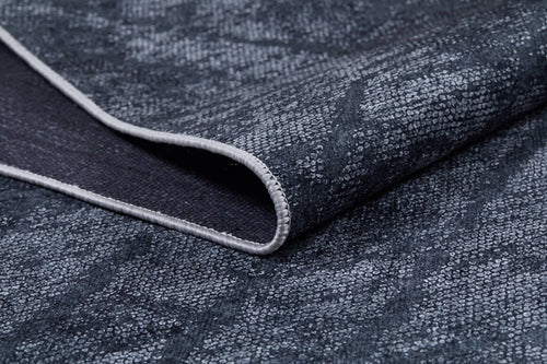 Load image 1 in gallery view. A close-up of the Geometric Gems - Washable Rug - JR1342 (Custom Size) in dark blue shows its textured, subtly patterned fabric and stitched edge—perfect for high-traffic areas and easily washable.