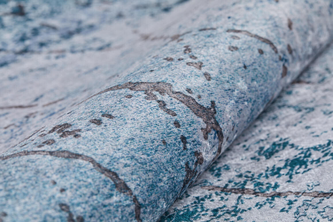 A close-up of blue and gray marbled wallpaper with dark, stone-like lines—ideal for pairing with the Geometric Glimmers - Washable Rug - JR1423 (Custom Size) in busy spaces.