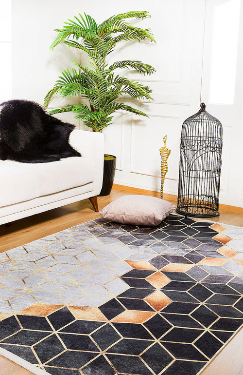 Load image 1 in gallery view. A modern living room featuring the Geometric Harmony - Washable Rug - JR1271 (Custom Size) in gray-anthracite, a white sofa with a black fur throw, a potted green plant, gold cobra decor, an empty black birdcage, and a beige floor cushion.