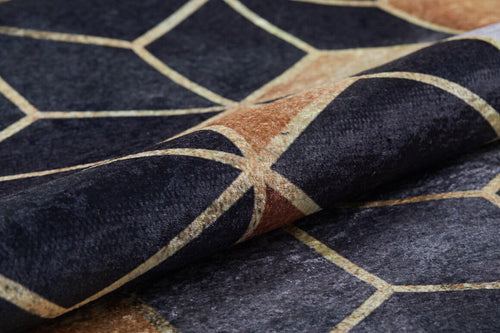 Load image 1 in gallery view. A close-up of the Geometric Harmony - Washable Rug - JR1271 (Custom Size) shows intersecting black, brown, and tan lines forming irregular polygons. Slightly folded, it highlights its washable texture—ideal for high-traffic areas.