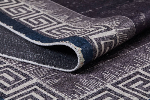 Load image 1 in gallery view. A close-up of the Geometric and Chic - Washable Rug - JR1273 (Custom Size), featuring a dark tone and white Greek key border pattern, partially folded to show front and back textures—perfect for high-traffic spaces.