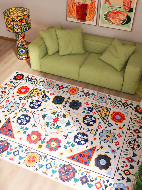 Load image 1 in gallery view. A bright living room showcases a light green sofa, matching lampshade, and two vibrant art prints above. The Global Gathering - Washable Rug - JR608 adds color and durability, perfectly complementing the wooden floors and cozy vibe.