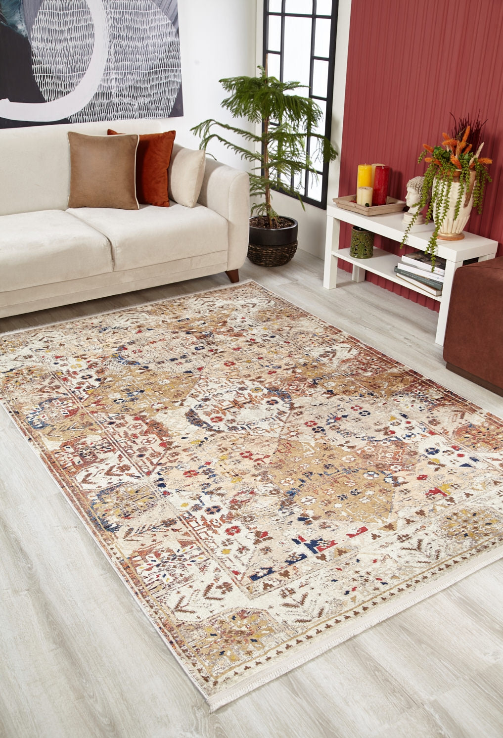 The Global Getaway - Washable Rug - JR1667 (Custom Size), a beige patterned flat weave with red, blue, and gold accents, is displayed on a light wood floor in a modern living room with a cream sofa and stylish decor.