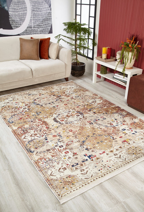 Load image 1 in gallery view. The Global Getaway - Washable Rug - JR1667 (Custom Size), a beige patterned flat weave with red, blue, and gold accents, is displayed on a light wood floor in a modern living room with a cream sofa and stylish decor.