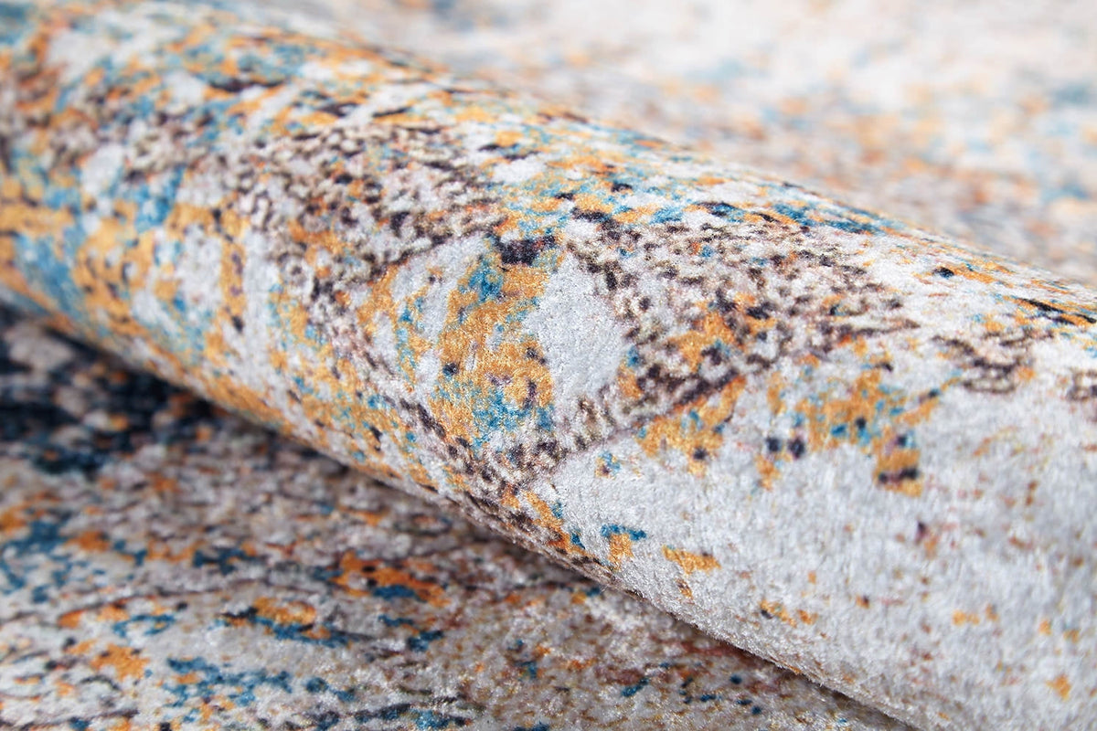 Close-up of the Global Glamour - Washable Rug - JR1708 (Custom Size) featuring a rolled, textured design in gray, cream, blue, and orange with an abstract geometric pattern—ideal for high-traffic areas.