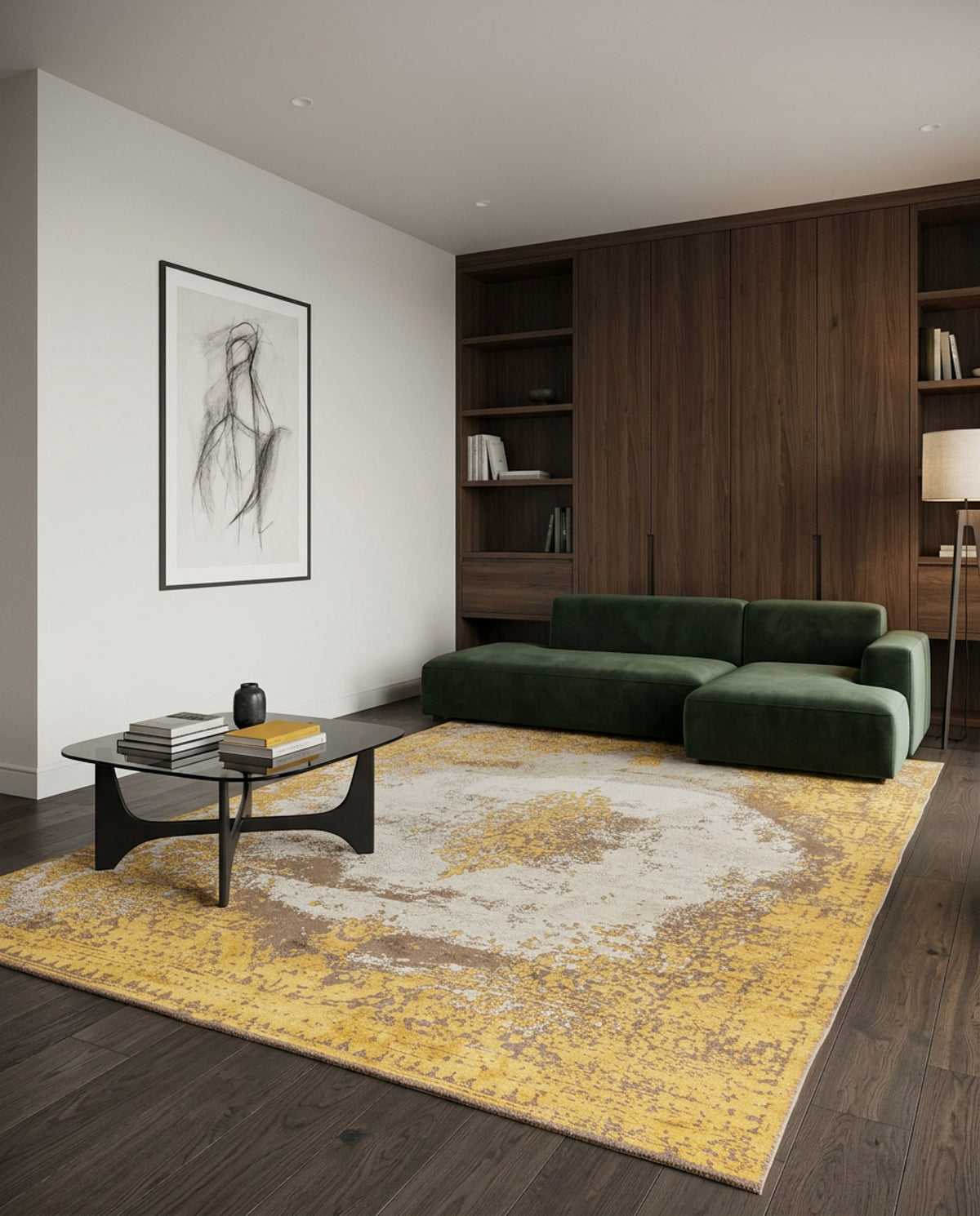 A modern living room with a green sofa, black coffee table with books, wooden built-in shelves, standing lamp, abstract art on a white wall, and the striking Golden Fade Area Rug APX1922 with a yellow pattern.