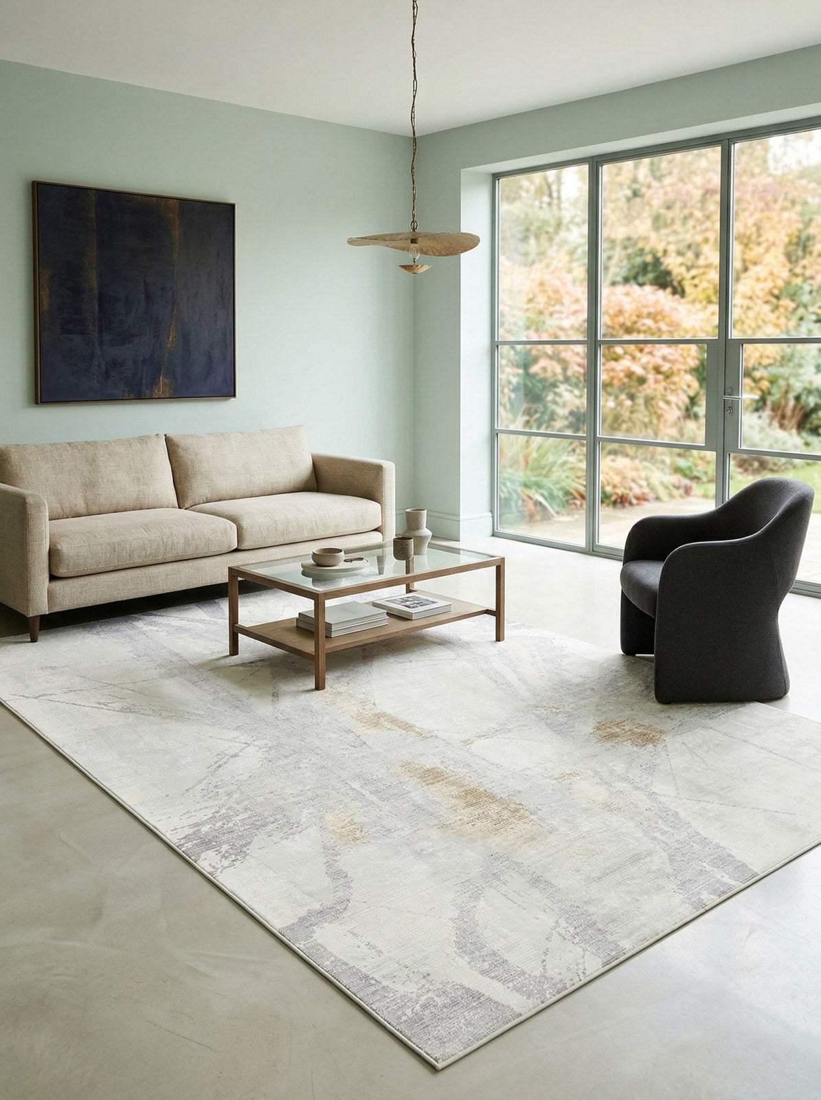 Light gray and beige abstract area rug with subtle distressed geometric lines, styled in a modern living room.