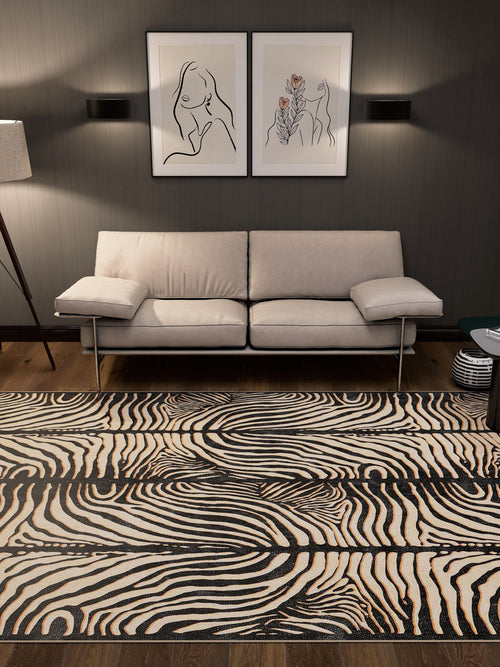 Load image 1 in gallery view. A modern living room with a beige sofa, two minimalist line art prints above it, wall sconces, a floor lamp, and the Gossamer Fade - Washable Rug - JRN44 in custom size featuring black and white swirl patterns.