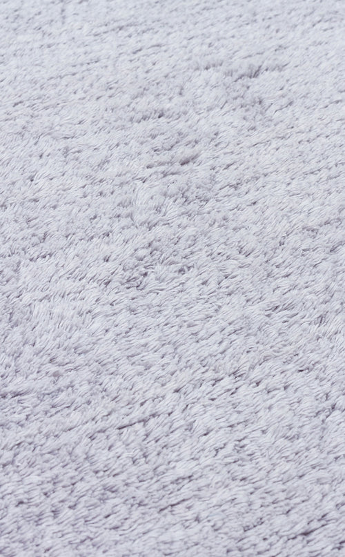 Load image 1 in gallery view. Close-up of the Grey Snug - Washable Shaggy (CBNPLAIN), a light gray, plush, textured rug—perfect for adding cozy comfort and modern style to any bedroom.