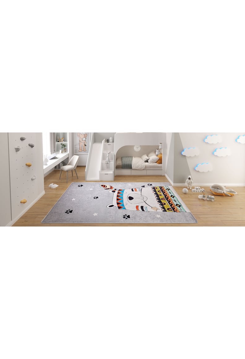 A children’s bedroom with a bunk bed, small desk, climbing wall, and the Groovy Bear - Machine-Washable Rug JRC093, featuring a cute cartoon bear in a colorful headband—perfect for high-traffic areas. Cloud wall decals and plush toys complete the playful decor.