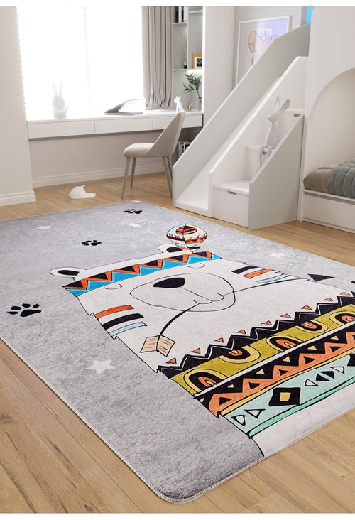 Load image 1 in gallery view. A kids' room with a slide and light wood flooring features the Groovy Bear - Machine-Washable Rug JRC093 in gray-anthracite, showcasing a cartoon bear with colorful tribal patterns and paw prints. A chair is by the window; a plush bunny rests on the slide steps.