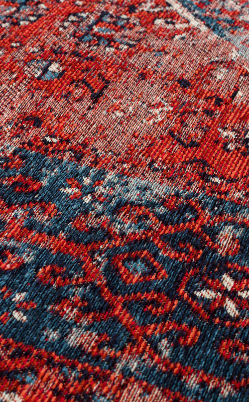 Load image 1 in gallery view. Close-up of the Heritage Blend - Washable Kilims - AND02, showcasing intricate red, blue, and white motifs on a textured woven surface. This washable kilim offers a slightly distressed look—an ideal choice for allergy-conscious spaces