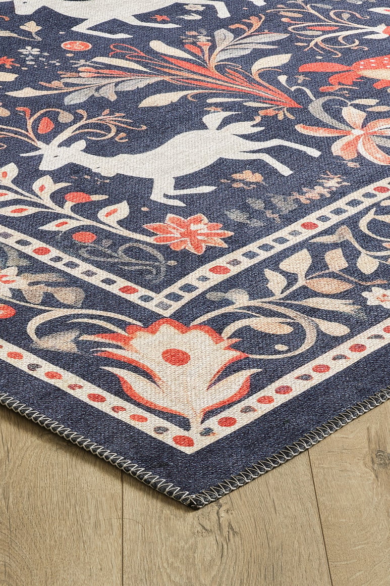 A close-up of the Holiday Heart Washable Area Rug - MDJ001 (Custom Size), featuring a folk-inspired design with white animals, floral patterns, and borders in navy blue, cream, and red—perfect for high-traffic wooden floors.