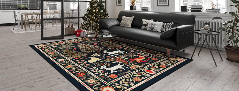 A modern living room with a black leather sofa and the Holiday Heart Washable Area Rug - MDJ001 (Custom Size), featuring animal and floral motifs—ideal for high-traffic areas. A decorated Christmas tree with gifts is set near large windows and a dining area.