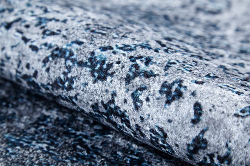 Bild 1 in Galerieansicht laden. Close-up of the Imperial Lace - Washable Rug - JR1607 (Custom Size) in textured blue with a mottled gray, blue, and black pattern, soft fuzzy surface, rolled edge—ideal for high-traffic areas and easy care thanks to its washable design.
