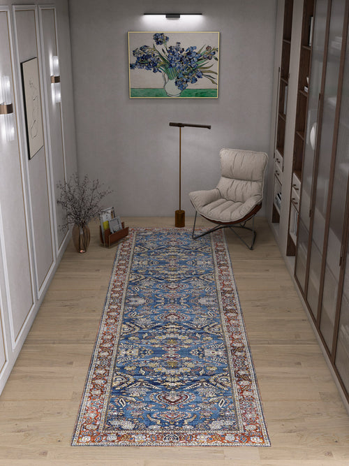 Load image 1 in gallery view. A cozy reading nook with a cushioned chair, standing lamp, vase with branches, and the Imperial Medallion - Washable Rug - JRN1006 (Custom Size) in vibrant blue on a light wood floor, plus artwork and shelves on the walls.