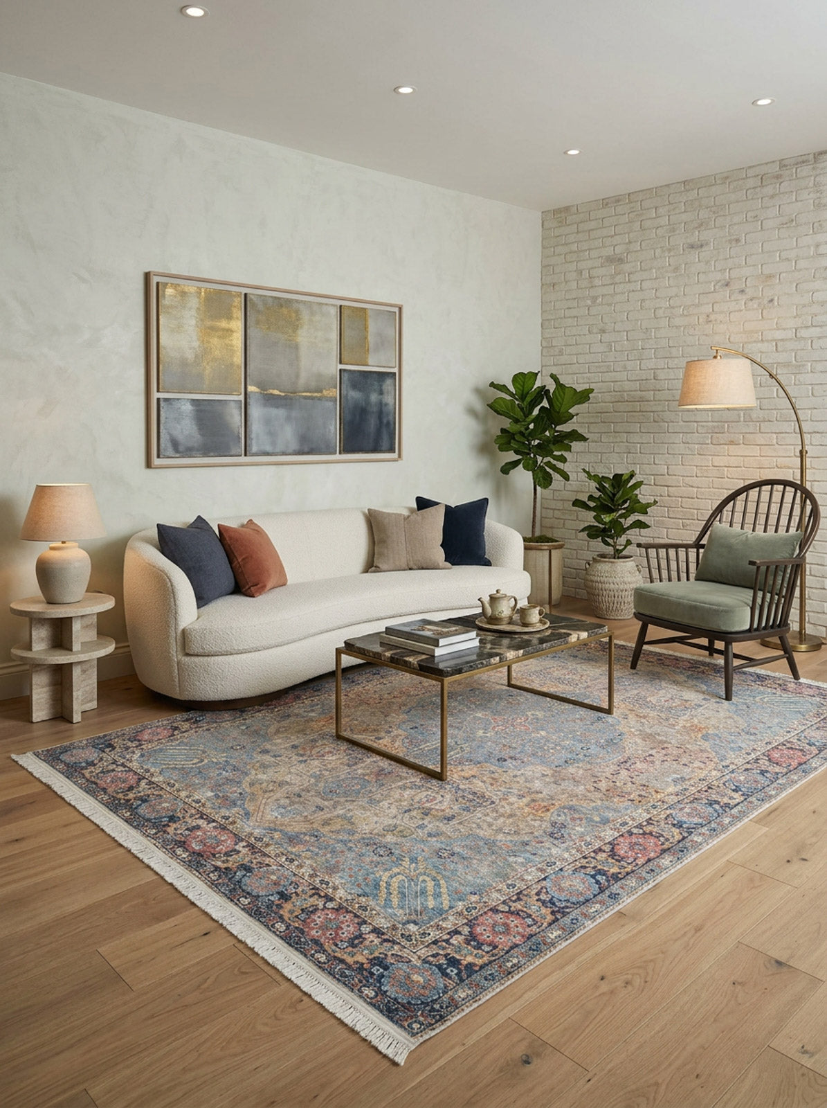 A modern living room with a white curved sofa, colorful pillows, wooden armchair, gold-framed coffee table, the Imperial Weave - Washable Rug - JR1969 ideal for high-traffic areas, framed abstract art, potted plants, and warm ambient lighting.