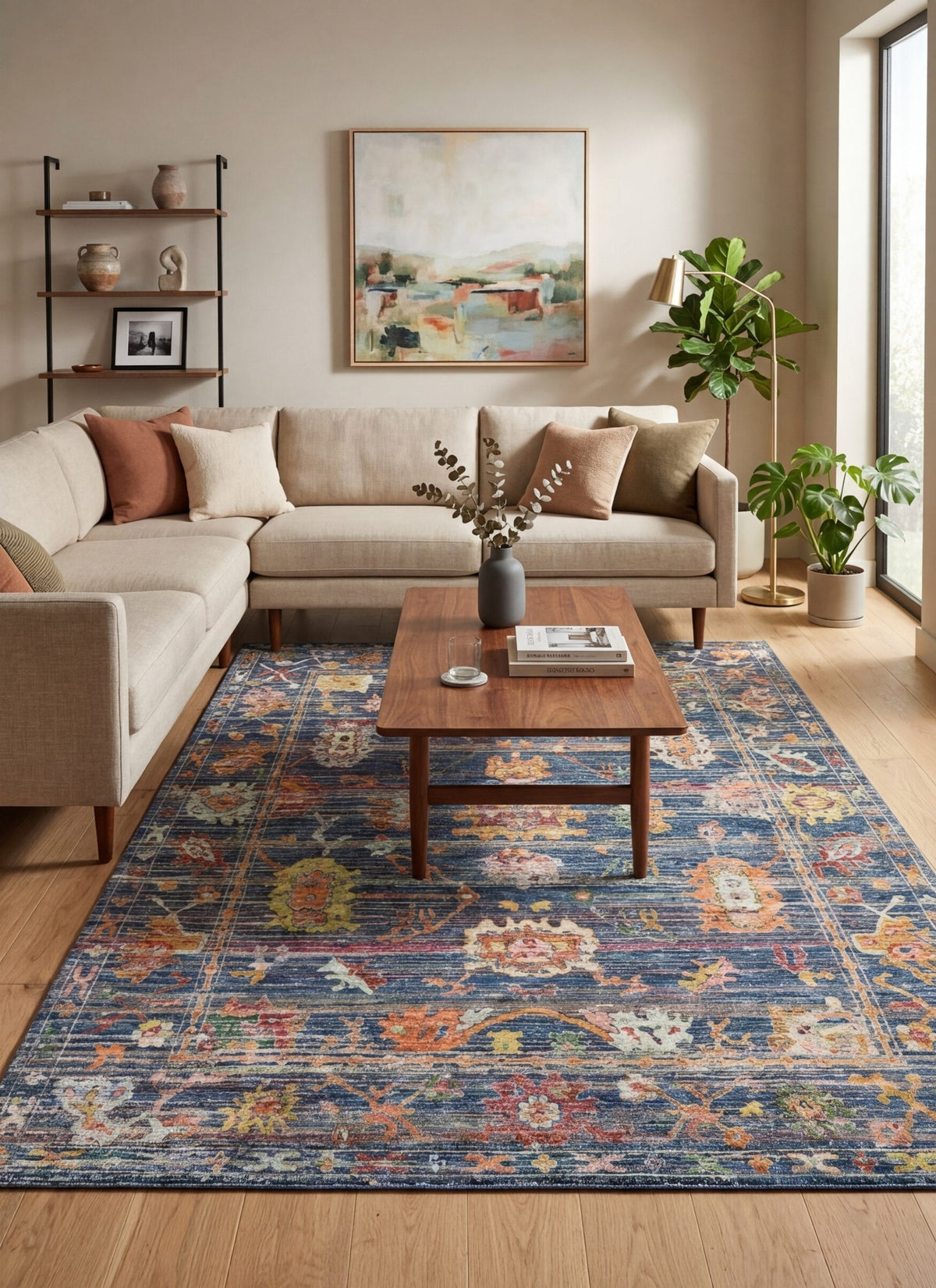 Navy blue traditional rug with a distressed floral medallion pattern, styled in a modern living room.