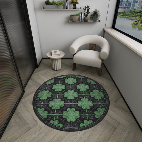 Load image 1 in gallery view. Round black rug with a green clover grid pattern, styled in a modern room with a white chair and side table.