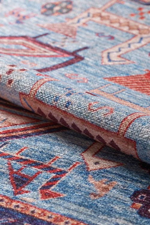Load image 1 in gallery view. A close-up of the Birdwatcher's Dream Blue Washable Rug - LCC3020 (Custom Size), featuring intricate geometric and abstract patterns in red, pink, and cream—ideal as a washable rug for high-traffic spaces.