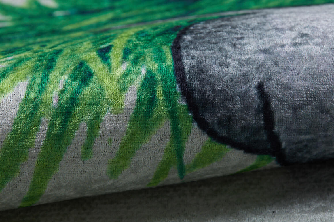 Close-up of the Joyful Elephant - Machine-Washable Rug JRC026 (Custom Size), showing its allergy-friendly flat weave, green grass-like patterns, and a rounded gray shape that highlights its unique printed design and texture.