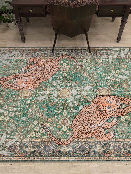 Load image 1 in gallery view. The Jungle Ember - Washable Rug - JR0047, featuring an ornate floral pattern and two large leopards, adds a decorative touch under a desk and chair on a wooden floor.