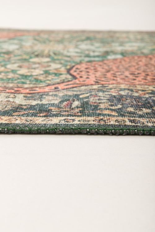 Load image 1 in gallery view. Close-up of the Jungle Ember Washable Rug (JR0047) laying flat on a light surface, highlighting its intricate geometric pattern in green, red, and beige.