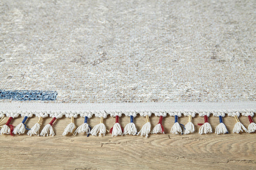 Load image 1 in gallery view. Close-up of the Kaleidoscope Dreams - Washable Rug - JR5055 (Custom Size), light-colored with white, red, and blue tassels on a wooden floor. Subtle, faded pattern—ideal for high-traffic or allergy-sensitive areas.