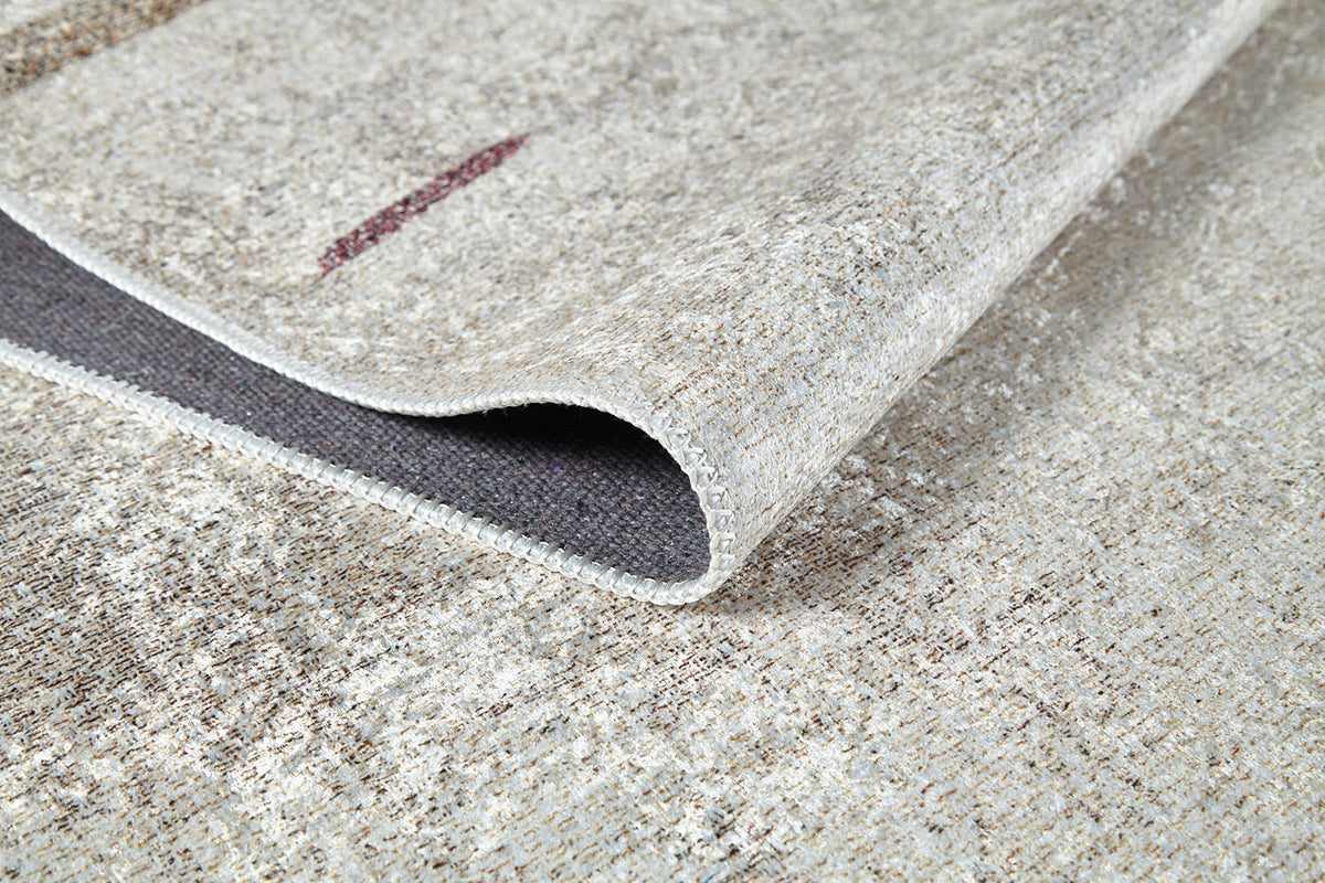 A close-up of the Kaleidoscope Dreams - Washable Rug - JR5055 (Custom Size) in beige and brown with a folded corner, highlighting its woven texture and detailed edging—perfect for high-traffic or allergy-sensitive spaces.