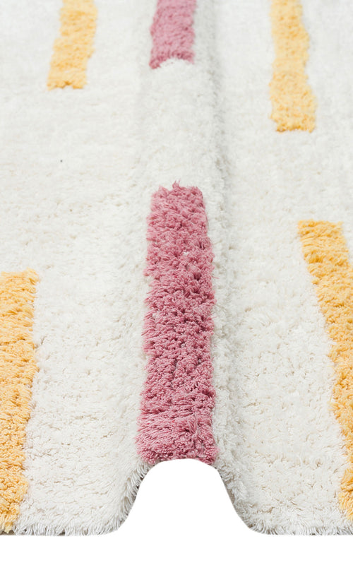 Load image 1 in gallery view. A close-up of the Little Steps - Washable Shaggy - CBN03 rug shows vertical pink and yellow stripes. The white multicolour rug is slightly raised in the center, revealing its plush, thick, and soft texture.