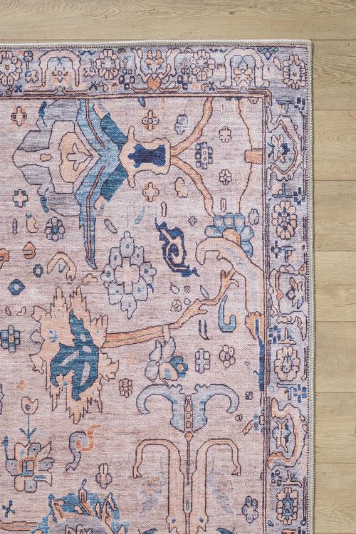 Load image 1 in gallery view. A close-up of the Luminary Beige Gray Washable Rug - LCC3023 (Custom Size), featuring a traditional floral pattern in pink, blue, and beige on a light wood floor. Only the corner and part of the rug’s edge are visible—perfect for high-traffic areas.