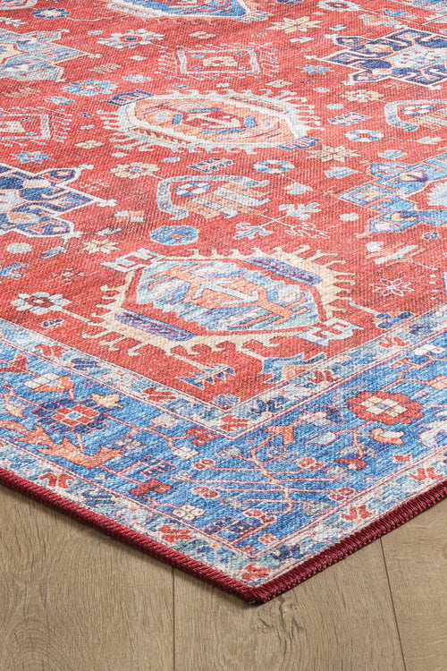 Load image 1 in gallery view. A close-up of the Lunavale Red Blue Washable Rug - LCC3007 (Custom Size), featuring geometric and floral patterns in red, blue, and cream on a wooden floor. Ideal for high-traffic areas with a decorative border; easy to clean.