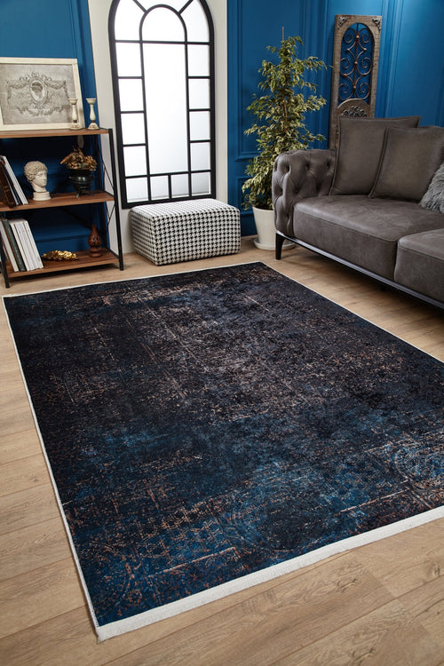 Load image 1 in gallery view. A cozy living room with the Luxurious Fleur - Washable Rug - JR1897 (Custom Size), perfect for high-traffic areas, paired with light wood flooring, a gray tufted sofa, potted plant, bookshelves, black and white ottoman, and an arched window.