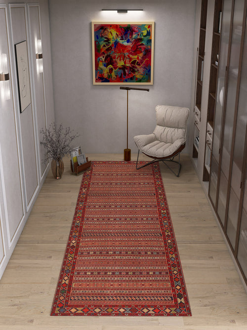 Load image 1 in gallery view. A modern room with light wood floors, a Majestic Loom Washable Rug (JRN1003) in red, a white cushioned chair, floor lamp, glass vase with twigs, colorful abstract painting on the wall, and shelves on the right.