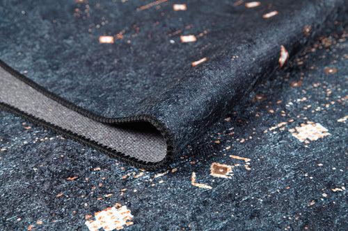 Load image 1 in gallery view. A close-up of the Midnight Majesty - Machine-Washable Rug (JRS5052, Custom Size) in dark blue, featuring a folded corner that highlights its textured surface and intricate white and light brown geometric patterns—ideal for high-traffic areas.