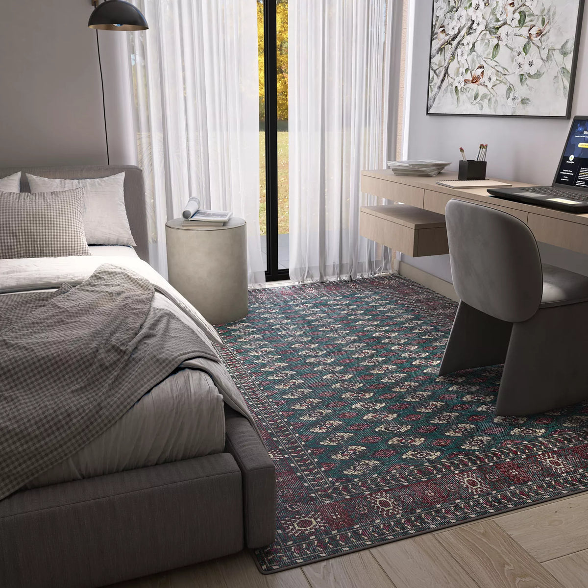 Modern bedroom with a gray bed, checkered bedding, small round bedside table, and the Midnight Tribal - Washable Rug - JRN1034—perfect for high-traffic areas. Includes a floating desk with computer, gray chair, large window with sheer curtains, and wall art.