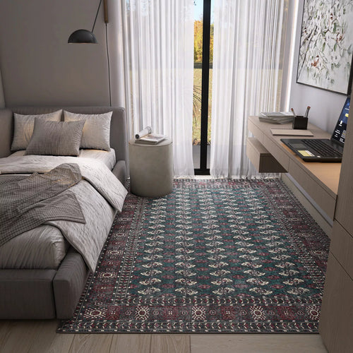 Load image 1 in gallery view. A modern bedroom with a gray bed, pillows, throws, a Midnight Tribal - Washable Rug - JRN1034 perfect for high-traffic areas, a round gray ottoman, desk with laptop, wall lamp, and large windows with sheer white curtains letting in light.