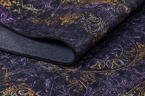 Load image 1 in gallery view. A close-up of the Minimalist and Elegant - Washable Rug - JR1298 shows its intricate gold, purple, and orange patterns. Partially folded to reveal a textured underside, this custom-size rug is perfect for high-traffic areas.