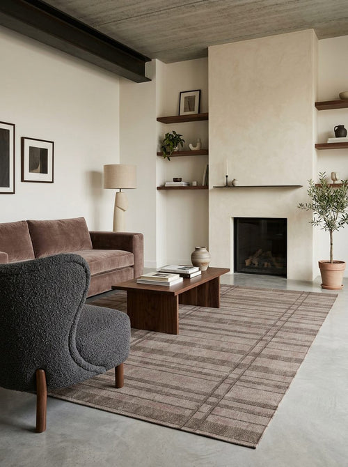 Bild 1 in Galerieansicht laden. Taupe and brown plaid rug with a subtle distressed texture, styled in a modern living room.