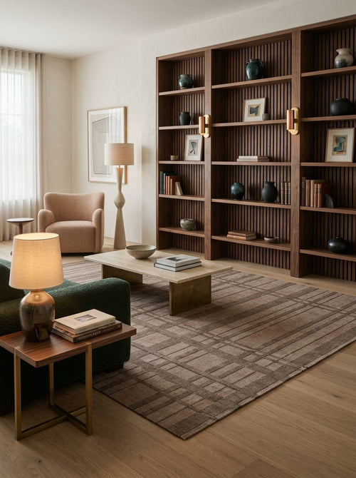 Bild 1 in Galerieansicht laden. Brown and taupe rug with a grid-like geometric pattern, styled in a modern living room with wood shelving.