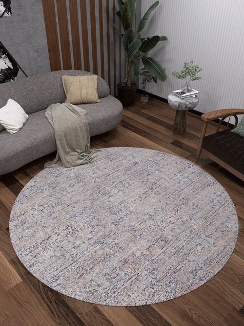 Load image 1 in gallery view. A cozy living room featuring the Modern Enigma - Machine-Washable Rug JR1883 (Custom Size) on wooden flooring, a curved gray sofa, cushions, a wooden chair, potted plants, and modern decor—perfect for high-traffic areas.